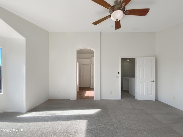 interior space with carpet flooring, a walk in closet, and ceiling fan