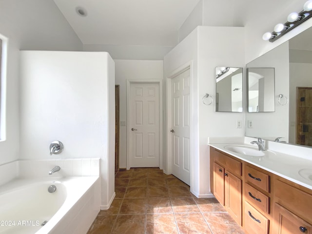 bathroom with vanity, a relaxing tiled tub, and tile patterned floors