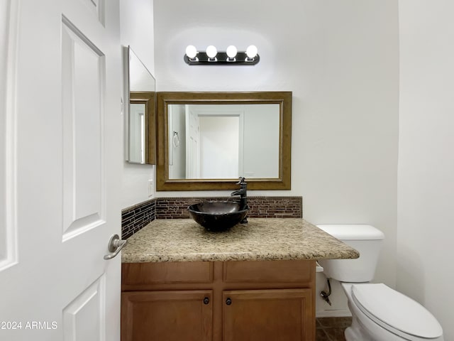 bathroom featuring tile patterned floors, vanity, and toilet