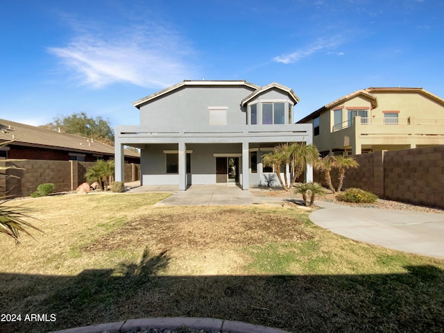 view of front of house with a patio and a front yard