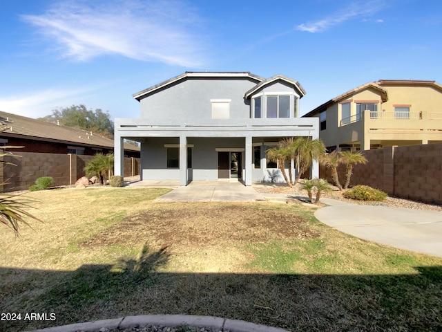 view of front facade with a patio and a front yard