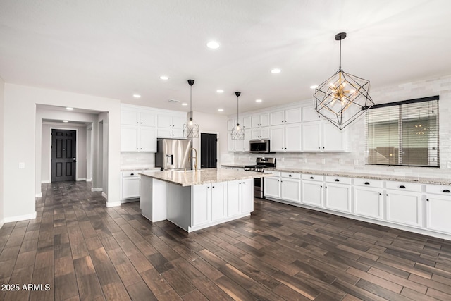 21972 N 97th Gln, Peoria, AZ 85383 - kitchen with stainless steel appliances, a notable chandelier, white cabinetry, and tasteful backsplash