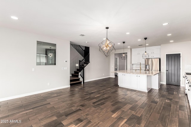 21972 N 97th Gln, Peoria, AZ 85383 - kitchen with stainless steel fridge with ice dispenser, recessed lighting, dark wood-style floors, and a chandelier
