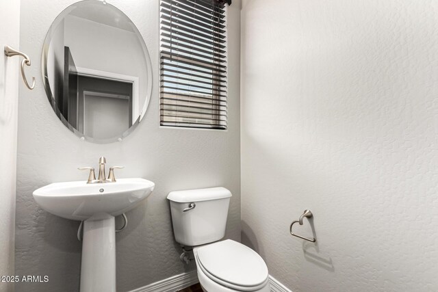 21972 N 97th Gln, Peoria, AZ 85383 - bathroom with baseboards and toilet