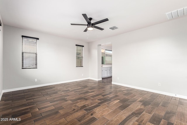 21972 N 97th Gln, Peoria, AZ 85383 - empty room featuring dark wood-style flooring, a ceiling fan, baseboards, and visible vents