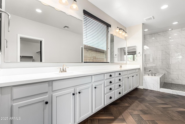 21972 N 97th Gln, Peoria, AZ 85383 - bathroom with tiled shower, visible vents, and a sink