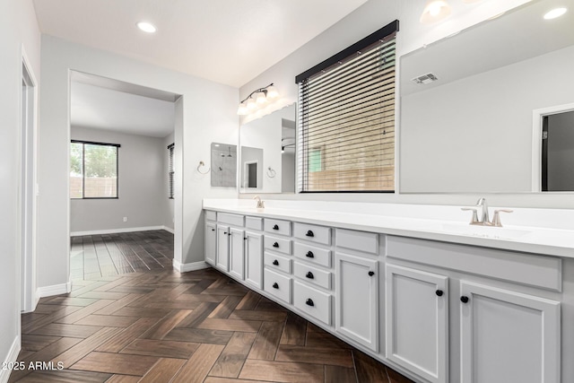 21972 N 97th Gln, Peoria, AZ 85383 - bathroom featuring a sink, baseboards, double vanity, and visible vents