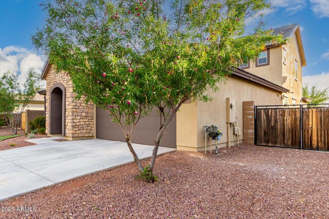 21972 N 97th Gln, Peoria, AZ 85383 - view of front of house with stucco siding, fence, stone siding, and concrete driveway