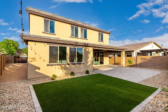 21972 N 97th Gln, Peoria, AZ 85383 - back of property featuring a patio, a fenced backyard, a lawn, and stucco siding