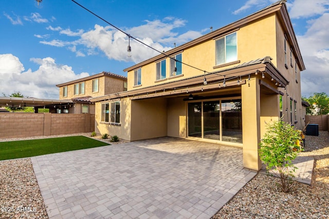 21972 N 97th Gln, Peoria, AZ 85383 - back of house with a fenced backyard, a patio, stucco siding, and central air condition unit