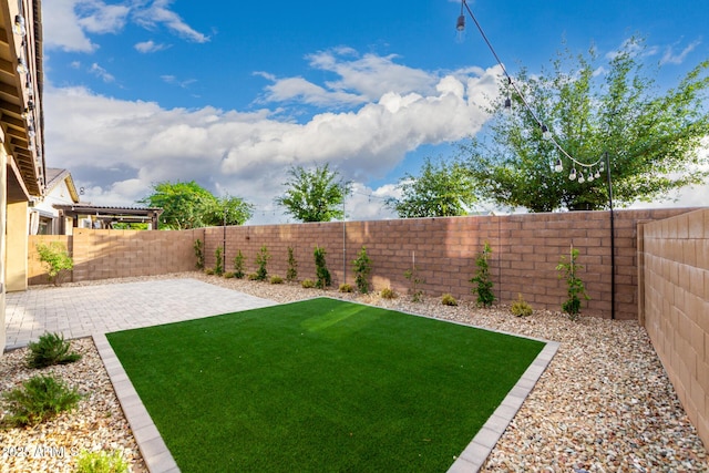 21972 N 97th Gln, Peoria, AZ 85383 - view of yard featuring a fenced backyard and a patio area
