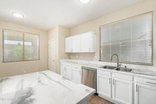 kitchen with dishwasher, white cabinets, light stone counters, and sink