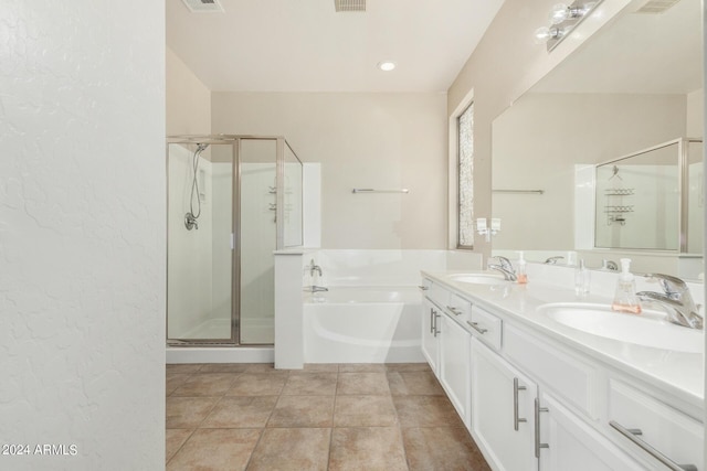 bathroom featuring tile patterned flooring, vanity, and separate shower and tub