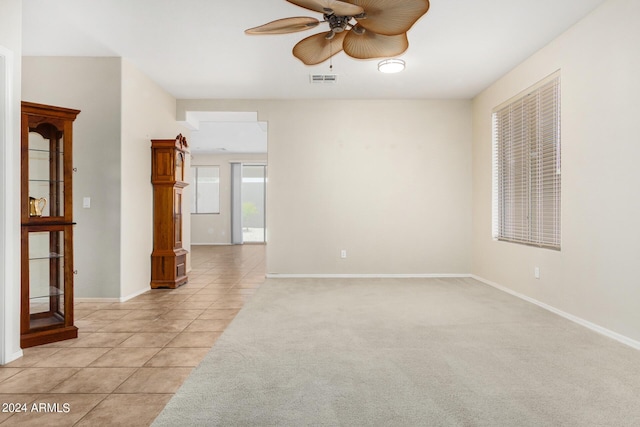 spare room featuring light tile patterned floors and ceiling fan