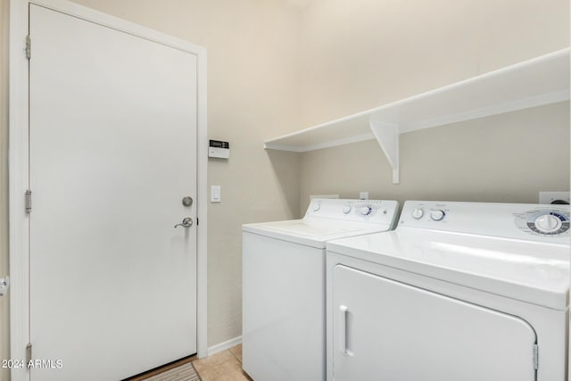 washroom featuring independent washer and dryer and light tile patterned flooring