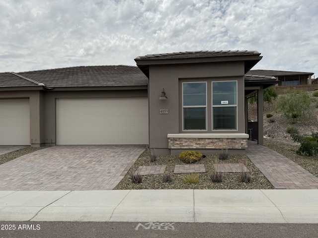 4155 Desert Moon Dr, Wickenburg, AZ 85390 - prairie-style home with decorative driveway, an attached garage, stucco siding, and stone siding