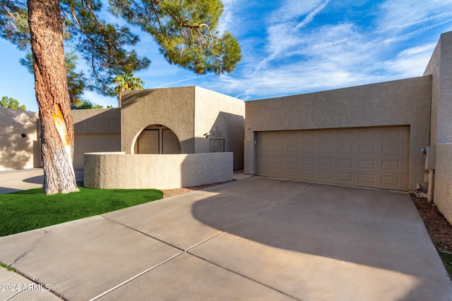 pueblo-style house with a garage