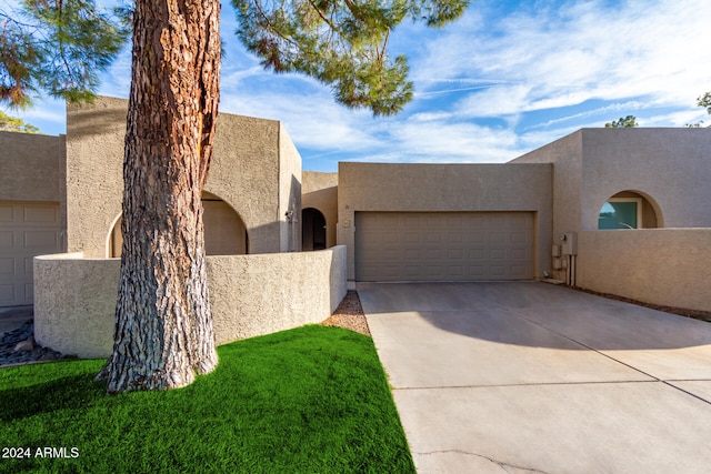 pueblo-style home featuring a garage