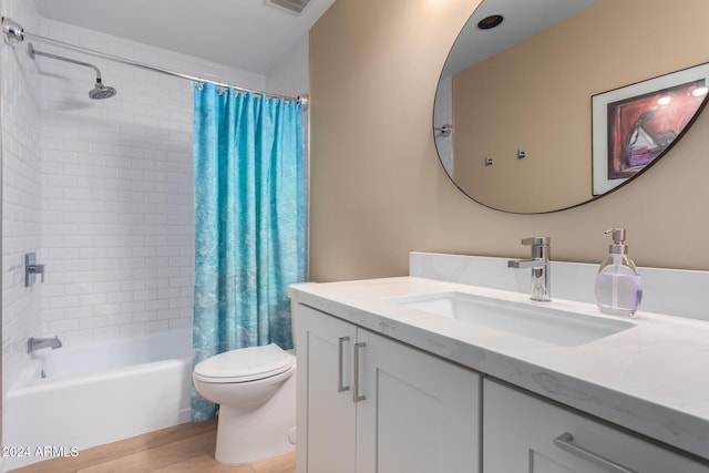 full bathroom with hardwood / wood-style flooring, vanity, toilet, and shower / tub combo with curtain