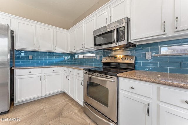 kitchen featuring white cabinets, backsplash, stone countertops, and stainless steel appliances