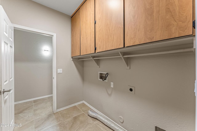 washroom featuring cabinets, washer hookup, hookup for an electric dryer, hookup for a gas dryer, and light tile patterned floors