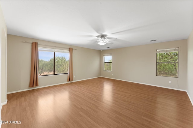 unfurnished room with hardwood / wood-style floors and ceiling fan