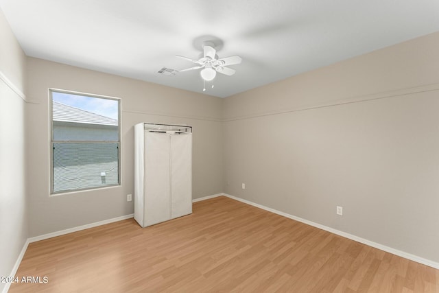 unfurnished bedroom featuring a closet, light hardwood / wood-style flooring, and ceiling fan