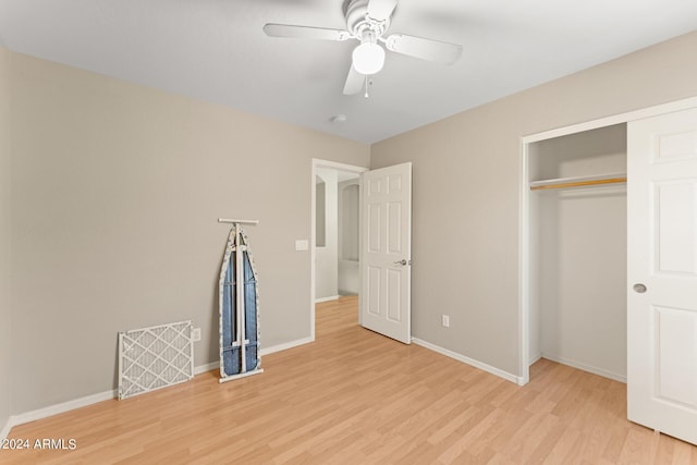 unfurnished bedroom with a closet, light hardwood / wood-style flooring, and ceiling fan