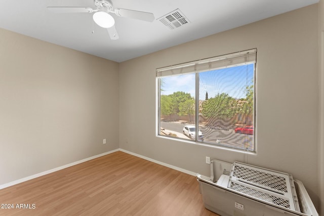 empty room featuring ceiling fan and light hardwood / wood-style floors