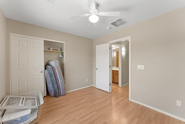 unfurnished bedroom featuring ceiling fan, light hardwood / wood-style floors, and a closet