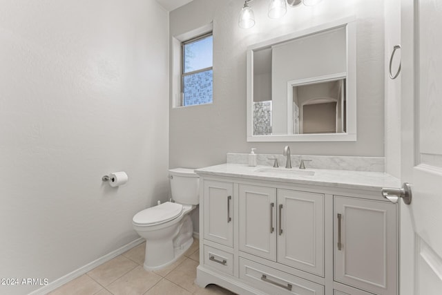 bathroom featuring tile patterned flooring, vanity, and toilet