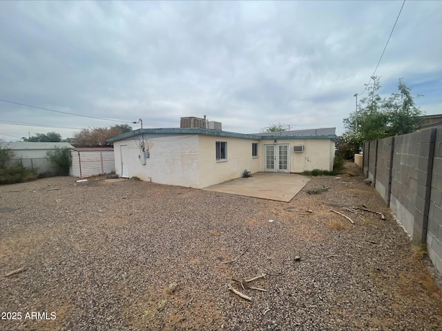 back of house with a patio area, fence, and french doors