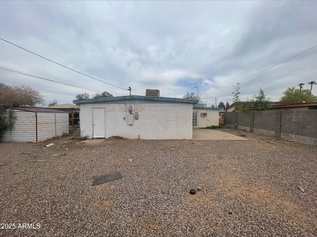 back of house with fence, an outbuilding, a patio area, and a shed