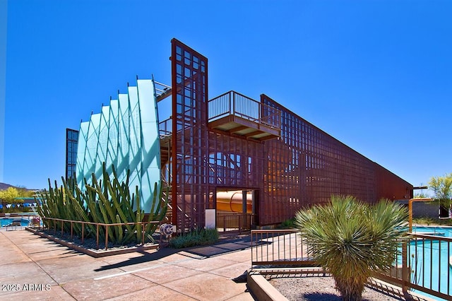 view of building exterior featuring a community pool