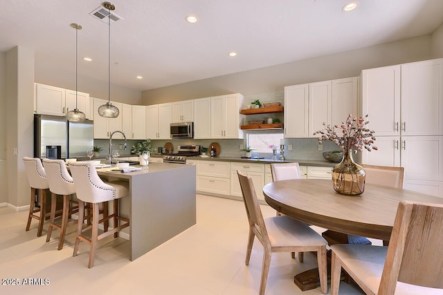 kitchen featuring recessed lighting, open shelves, decorative backsplash, and stainless steel appliances