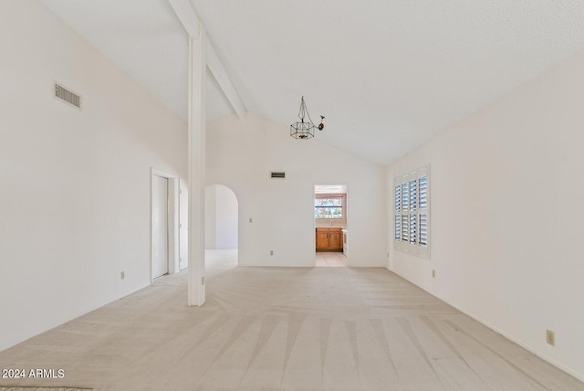 carpeted spare room featuring beamed ceiling, high vaulted ceiling, and a chandelier