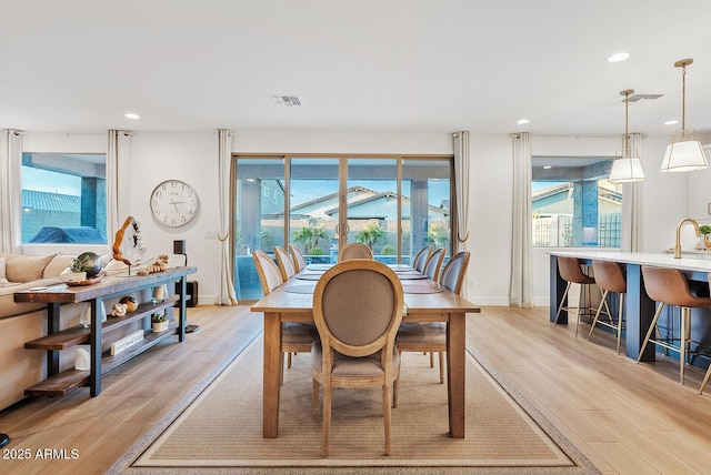 dining room featuring light hardwood / wood-style flooring and sink