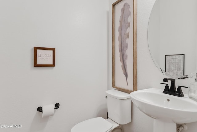 bathroom featuring sink and toilet