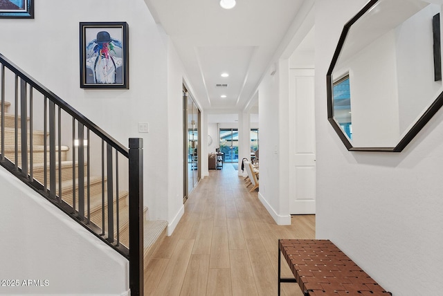 corridor with light hardwood / wood-style floors