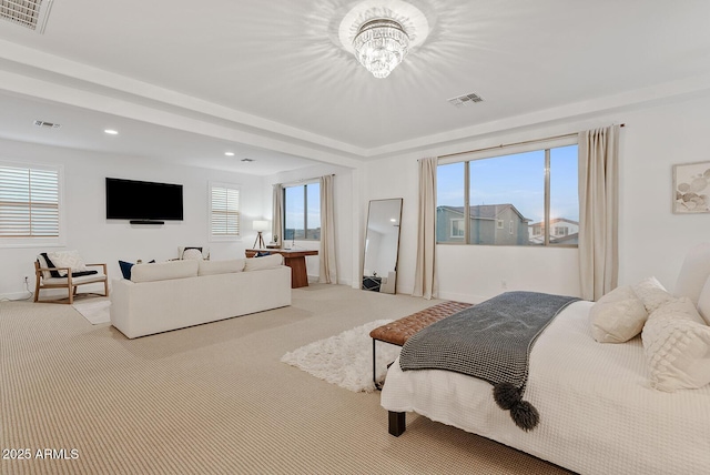 carpeted bedroom featuring an inviting chandelier and multiple windows