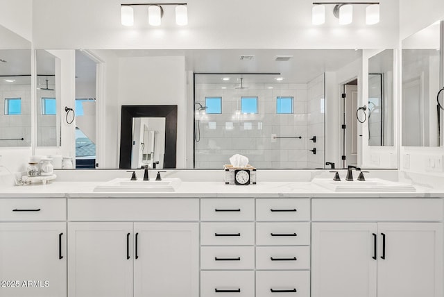 bathroom featuring vanity and a tile shower