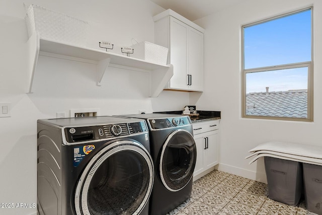 laundry area featuring cabinets, separate washer and dryer, and light tile patterned floors