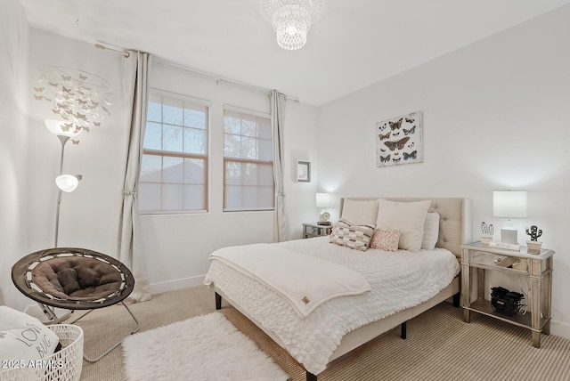 carpeted bedroom with a chandelier