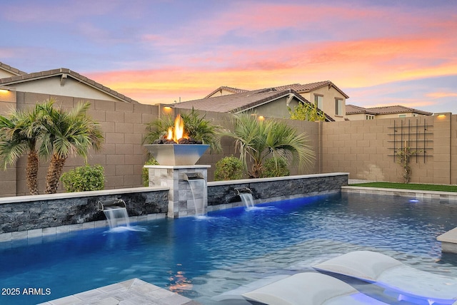 pool at dusk with pool water feature