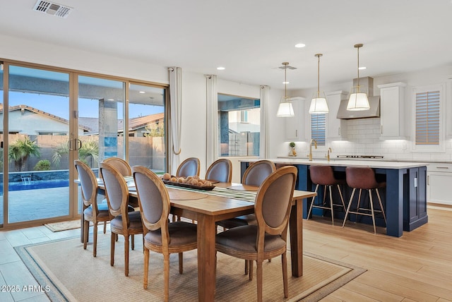 dining space with light hardwood / wood-style flooring