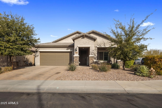 view of front of home featuring driveway, stone siding, stucco siding, fence, and an attached garage