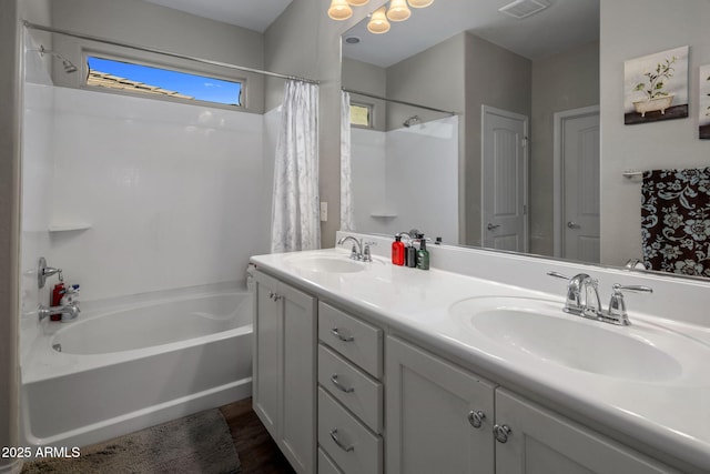 bathroom featuring double vanity, visible vents, shower / tub combo with curtain, and a sink