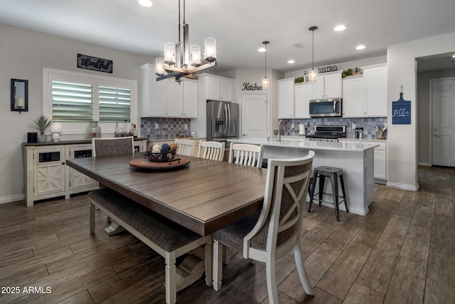 dining area with recessed lighting, baseboards, a chandelier, dark wood finished floors, and visible vents