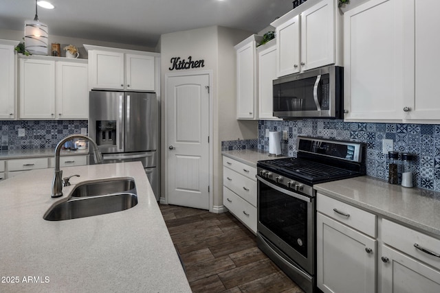 kitchen featuring light countertops, a sink, and stainless steel appliances