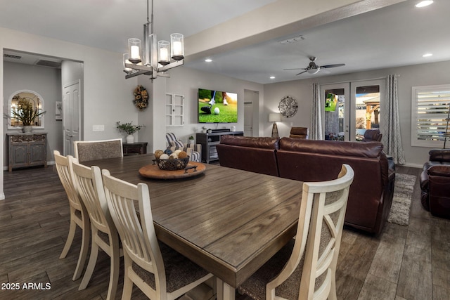 dining area with dark wood-style floors, visible vents, recessed lighting, and ceiling fan with notable chandelier